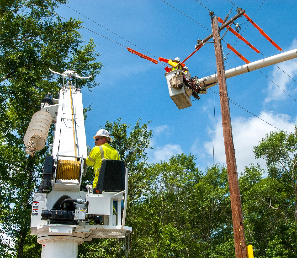 Installation of both overhead pole lines and underground buried cable to serve residential, commercial, and industrial loads